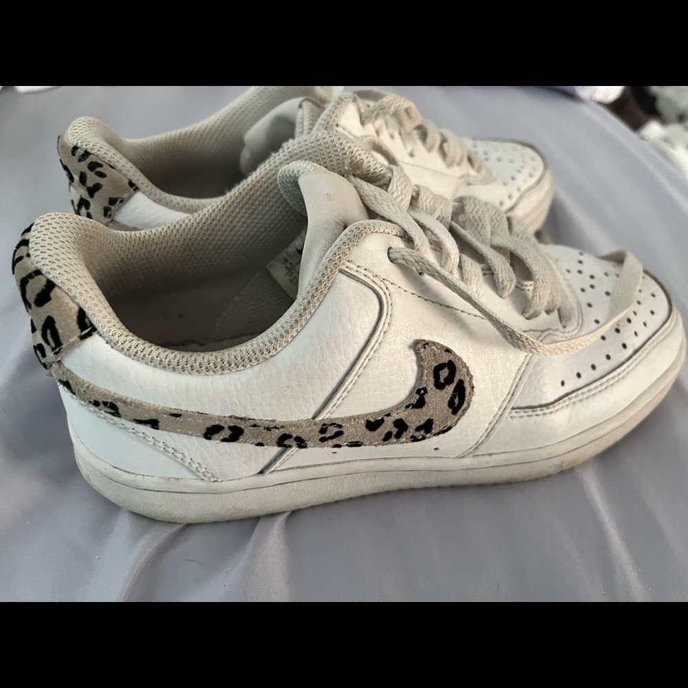 Nike shoes.. with with leopard swoosh…